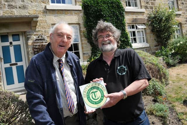 Mike Coupe, right, the secretary of the Tibshelf Local History and Civic Society, presents a Heritage Award plaque to Cecil Hill for a lifetime of conservation on his traditional Derbyshire long house home, Ashmore Farm, where he has lived since 1932.