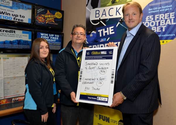 Chesterfield MP Toby Perkins places his free Â£50 bet from William Hill with winnings going to local charity, pictured are from left cashier Stacey Ward, shop manager Darren Green and MP Toby Perkins