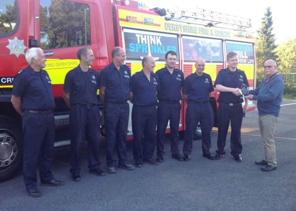 Crich retained firefighters are presented with a Community Award by David Billyeald.