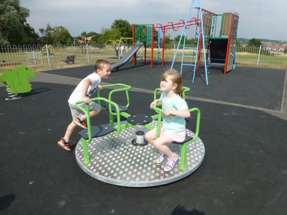 Fraser and Rosa Hunt try out the new play equipment at Whitecotes Playing Field, Chesterfield.