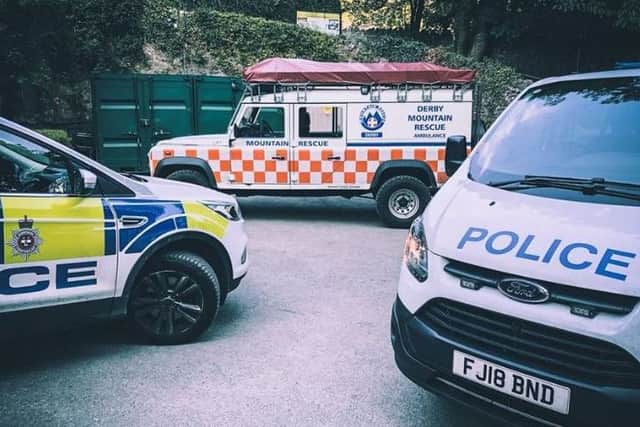 Police and rescue team vehicles at the scene. Pic: Derby Mountain Rescue