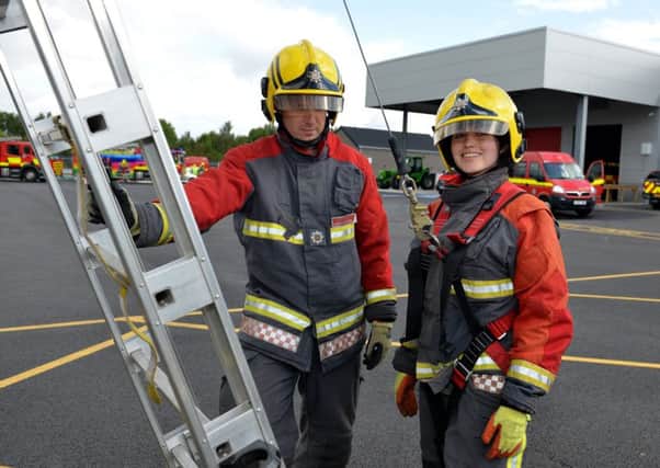 Miss Derbyshire Lauren Lolly Pain undertakes Firefighter tasks raising money for Beauty With A Purpose and Firefighters Charity, Lolly is pictured with crew manager Jamie Hughes
