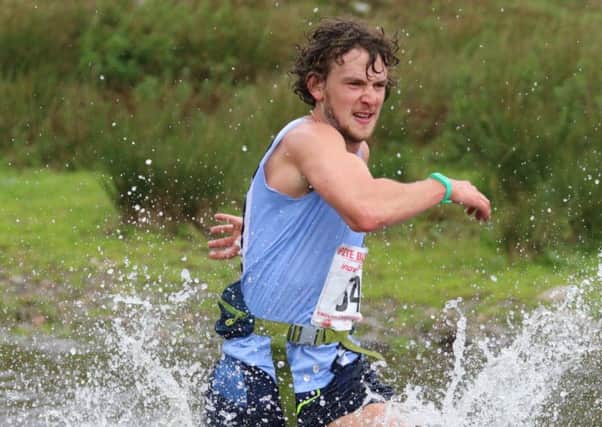 Billy Cartwright, of Matlock Athletics Club, makes a splash in the Cautley Horsehoe Fell Race.