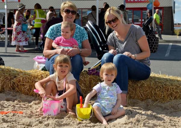 Clay Cross on the beach, pictured are Janet Walker with Connie Mosley, 9 months, Katie Mosley, Martha Mosley, three and Nancy Brown, one