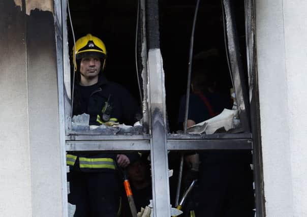 Firemen at Mennard House, Galway Street, Finsbury, London where a fire broke out in a third floor flat.
