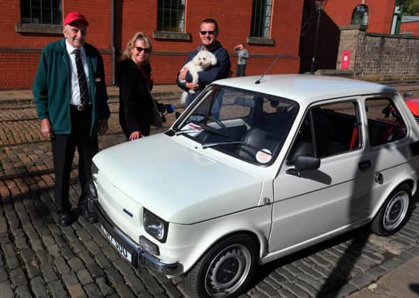 A collection of vintage cars were also on display.
Tramway volunteer John Lea along with visitors Lisa and Martin Gregory and dog Gretal  remonisce about their ownership of a Fiat car simular to this one.