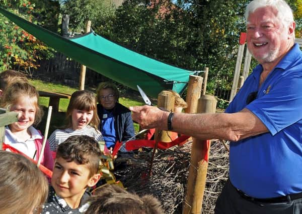 Alan Hepworth, the chairman of the Communities Committee for Dronfield Rotary Club, cuts the ribbon to open the new Forest School area at Holmesdale Infant School on Tuesday after the Club funded the outdoor space.