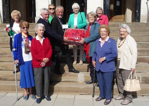 Chesterfield Morning Townswomen's Guild hand over knitted poppies to Councillor Steve Brunt and Rob Nash.