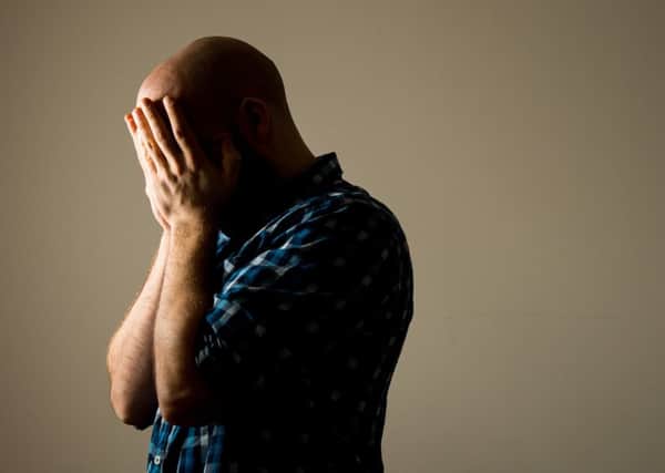 PICTURE POSED BY MODEL A man showing signs of depression.
