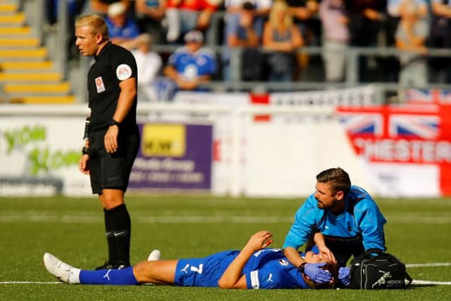 Picture by Matt Bristow/AHPIX.com;Football;Vanarama;Conference Premier;Maidstone United v Chesterfield FC;29/09/2018  KO 3.00pm; The Gallagher Stadium;copyright picture;Matt Bristow;07973 739229Chesterfields midfielder Charlie Carter lies bleeding on the floor adfter clashing withMaidstone's defender Will De Havilland