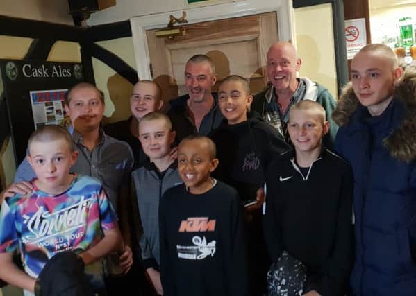 Members of the community who had their head shaved in support of Grindleford youngster Donte Tucker, centre, who has been diagnosed with Hodgkin's Lymphoma