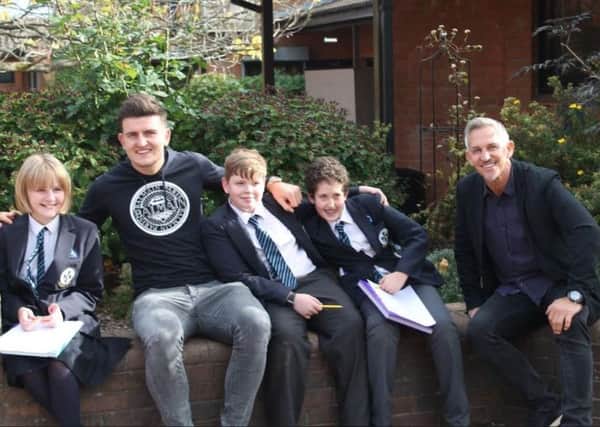 Gary Lineker pictured with England star Harry Maguire at his former school during a surprise visit.