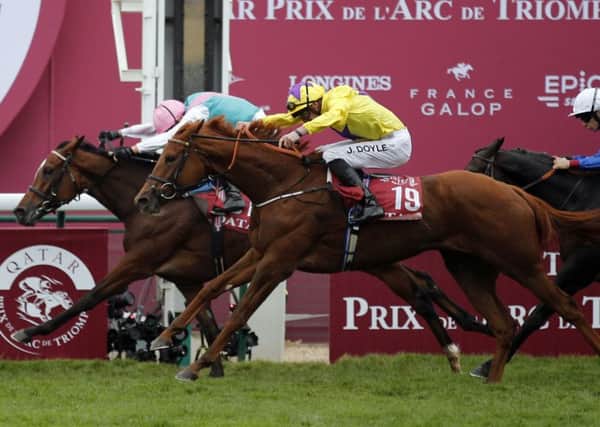 Enable, ridden by Frankie Dettori, just holds off fellow British filly Sea Of Class to win her second successive Qatar Ptix de l'Arc de Triomphe at Longchamp on Sunday.