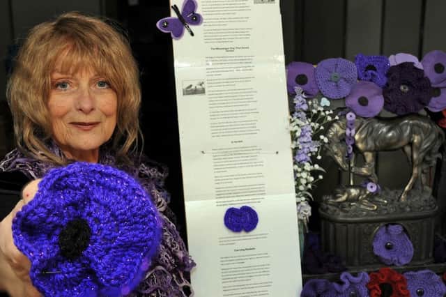 June Lane and her friends have made a display of purple poppies in honour of the animals which died during the First World War. Pictures by Anne Shelley.