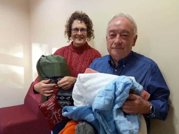 Jackie Taylor, leader, and Bob Littlewood, driver, with collection of items for Church on the Bus.