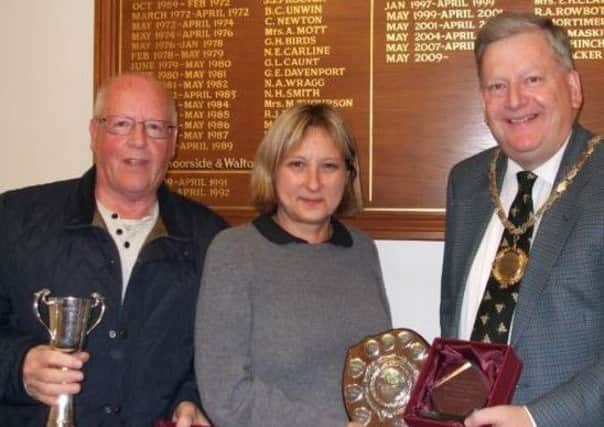 Councillor Martin Thacker, chairman of Holymoorside & Walton Parish Council, presents awards to David  Boyes (collecting on behalf of his brother Terry)  for the best kept allotment and  Trudy Kinirons for most improved allotment.