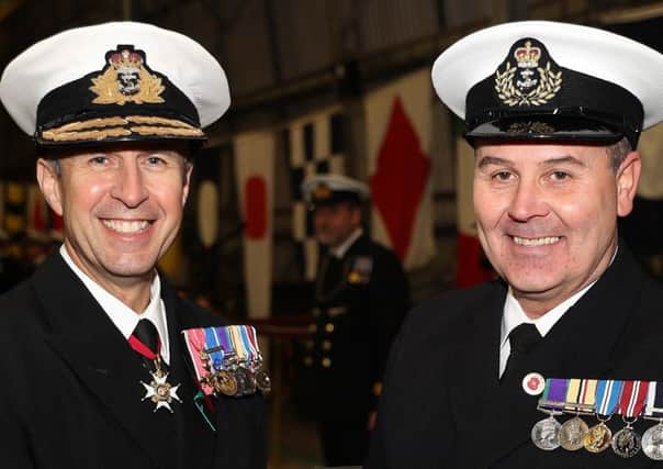 Royal Navy Warrant Officer Chris Fairey receives his 35 year clasp from Rear Admiral K Blount. Photo by Dave Gallagher.
