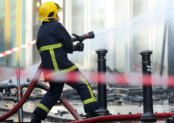 Embargoed to 0001 Tuesday March 27 Undated file photo of a firefighters tackling a blaze. Arsonists could face tougher punishments if their crimes result in damage to listed buildings or a major emergency response under new sentencing plans.