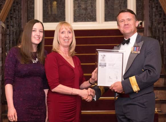 Fiona Clark and Stephanie Metham from Home Instead being presented with their certificate from Air Commodore Simon Edwards. Photo by Tracey Whitefoot.