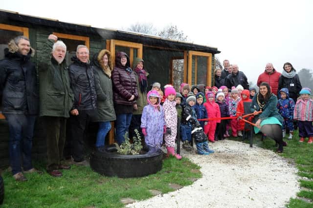 Staff and pupils at Darley Dale Primary School are joined by special guests including Darley Dale Mayor, Councillor Mary Myers, who braved a deluge for the opening of their outdoor forest classroom. Picture by Anne Shelley.