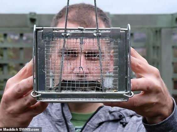 Mr Scriven with the cage. Photo - Tom Maddick/SWNS