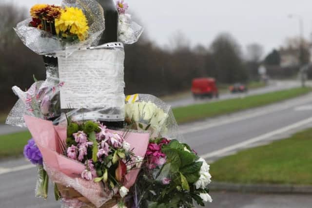 Tributes left at the scene of the crash in January.