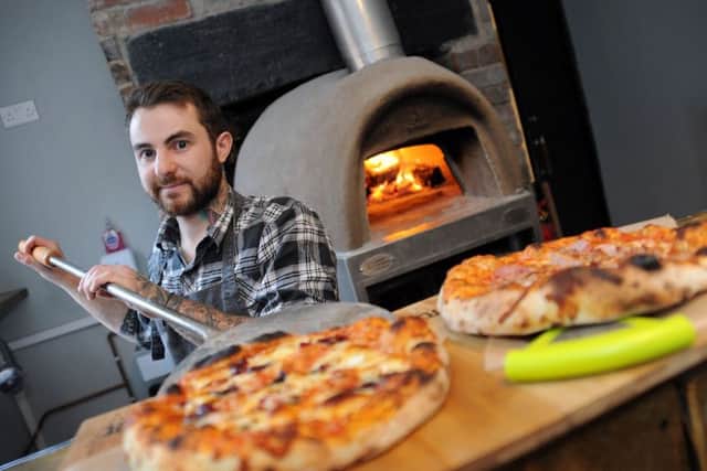 Ricky Marples, owner of Pizza Pi, on Beetwell Street, serves up his festive creations.