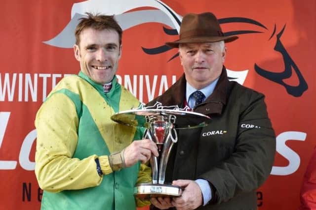Jockey Tom Scudamore and trainer Colin Tizzard with the Ladbrokes Trophy.