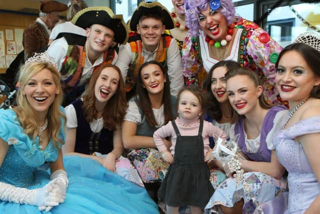 Sinead Auld, two, surrounded by cast members.