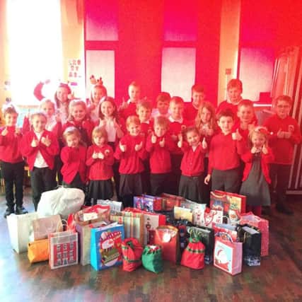 Cutthorpe Primary School pupils with their gift boxes for homeless people in Chesterfield.