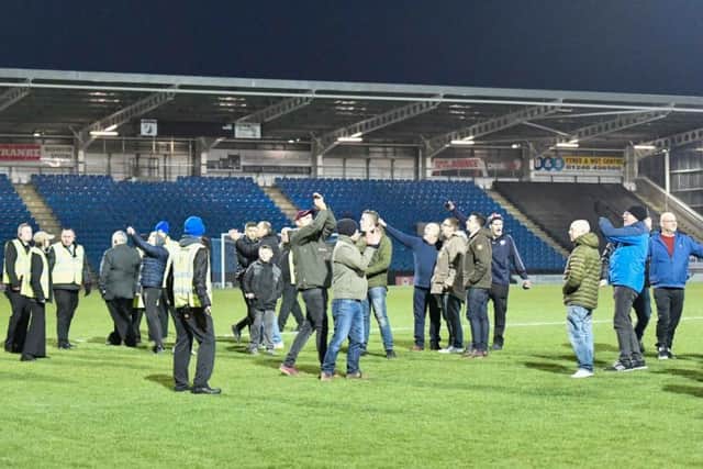 Fans invaded the pitch after Moors' third goal.