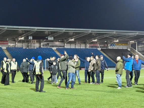 Fans invaded the pitch after Moors' third goal.