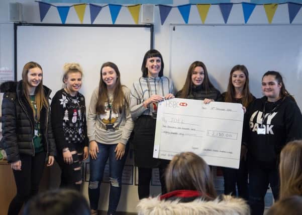 Students from Chesterfield College's Childhood Studies department present Â£2,180 to JOEL which supports families after the loss of a baby.