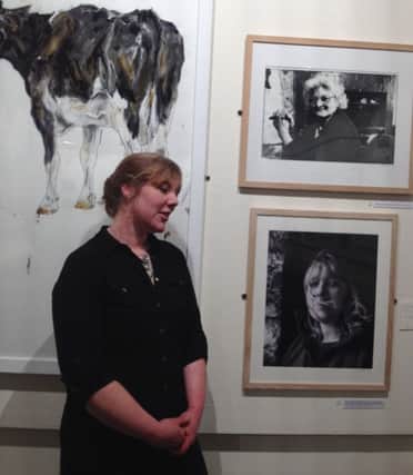 Emma Allsop next to her portrait and Mary Wain's portrait in The Hill exhibition at Buxton Museum and Art Gallery. Both strong independent farming women who farmed at the same farm but two generations apart. Photo courtesy of Kate Bellis