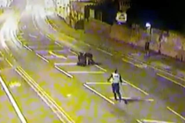The wanted man had run off from officers but was rugby tackled to the ground by two friends