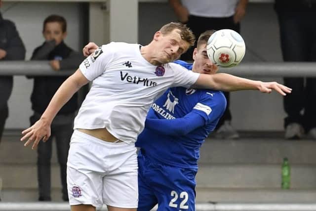 Chesterfield's Sam Muggleton competes for a header with AFC Fylde's Danny Rowe: withPicture by Steve Flynn/AHPIX.com, Football: The Emirates FA Cup - Qualifing Fourth Round match AFC Fylde -V- Chesterfield at Mill Farm, Wesham, Lancashire, England on copyright picture Howard Roe 07973 739229