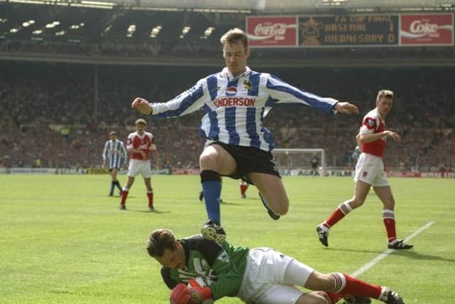 15 May 1993:  John Sheridan of Sheffield Wednesday leaps over goalkeeper David Seaman of Arsenal during the FA Cup final at Wembley Stadium in London. The match ended in a 1-1 draw. \ Mandatory Credit: Shaun  Botterill/Allsport