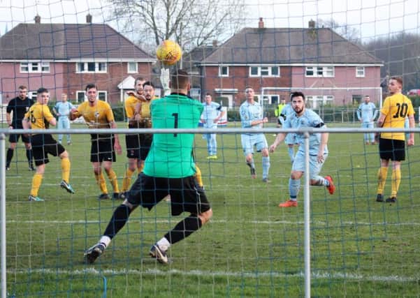 Thorne goalkeeper Richard Watson fails to hold a powerful strike from hat-trick hero Ant Lynam.