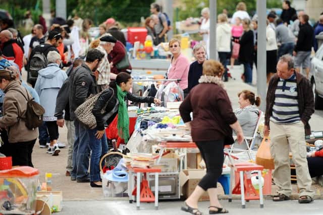 Bargain-hunters search a second-hand market (REMY GABALDA/AFP/GettyImages)