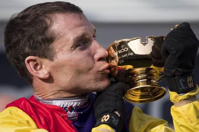 Champion jockey Richard Johnson kisses the Cheltenham Gold Cup after victory on Native River at last year's Festival. (PHOTO BY: Justin Setterfield/Getty Images)