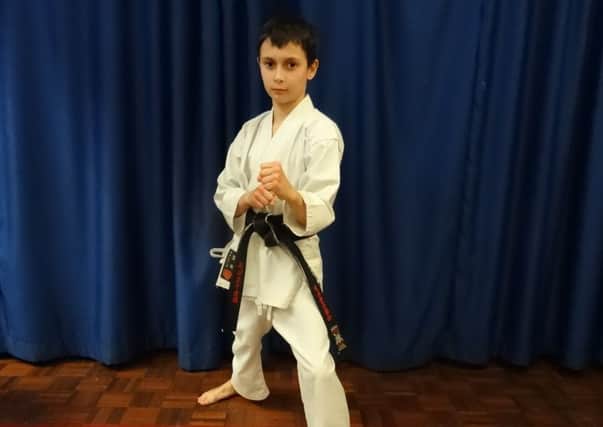 Aleksander Bendinger, who has gained a karate black belt at the age of nine.