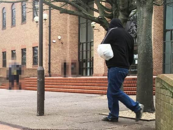 Brett Healey concealing his identity outside Derby Crown Court (Image: Derby Telegraph)