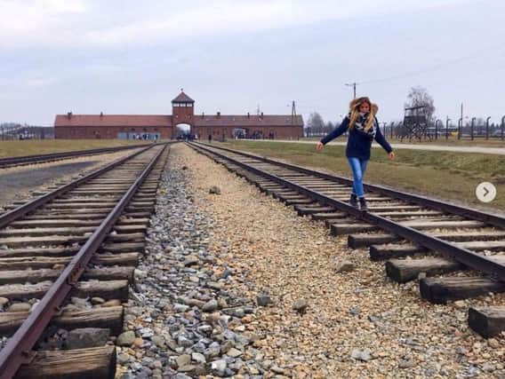 A young woman on the railway at Auschwitz. Photo:@AuschwitzMuseum.