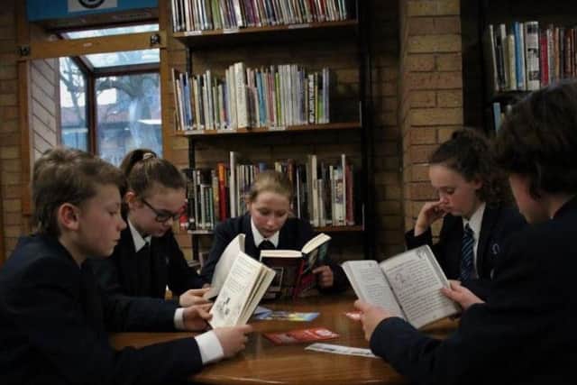 Year 7 pupils read in the school library.