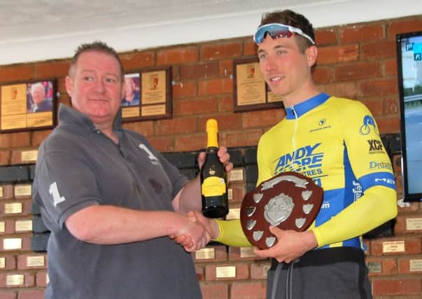 Damien El Dynamo Clayton receives his trophy after victory in the Upton Cycling Club Road Race.