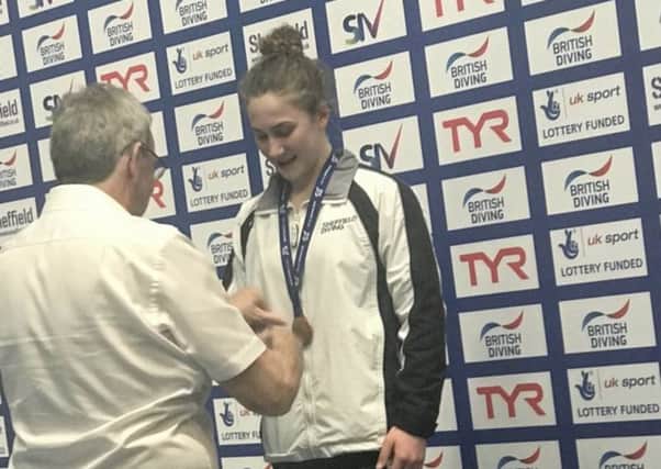 Chesterfield diver Grace Ally receives one of her national medals.