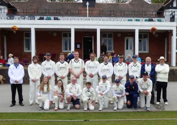 Players line up in front of the Queens Park pavilion for the anniversary match.