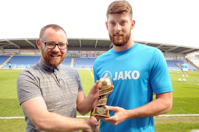 Will Evans is presented with the Derbyshire Times readers' player of the year trophy by our Chesterfield reporter, Graham Smyth.