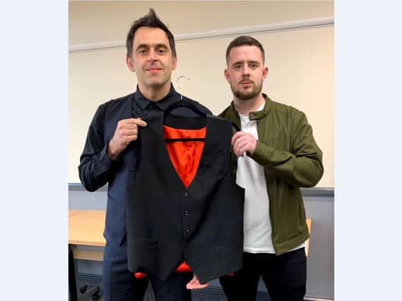Ronnie O'Sullivan hands over his record-breaking waistcoat to Dan Hoyland, co-owner at Redtooth Memorabilia.
