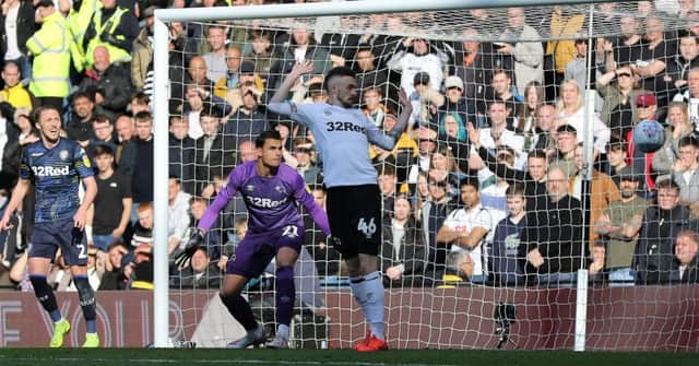 Derby County goalkeeper Kelle Roos and his team-mate defender Scott Malone watch on as the ball goes wide of the goal.